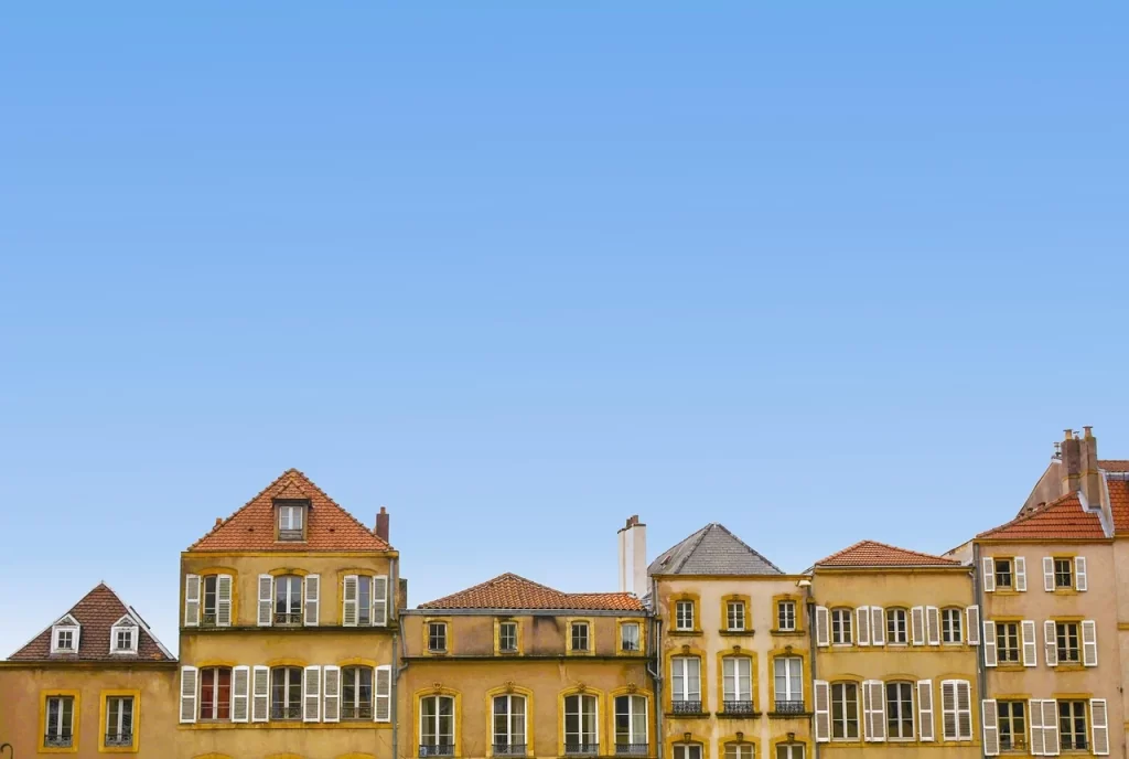 Classic residential buildings with elegant architecture and shuttered windows, representing premium housing options in urban neighborhoods.