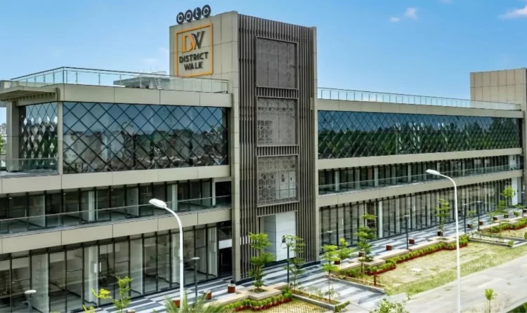 Front view of BPTP District Walk's contemporary commercial complex in Sector 81, Faridabad, showcasing its sleek glass facade and landscaped surroundings