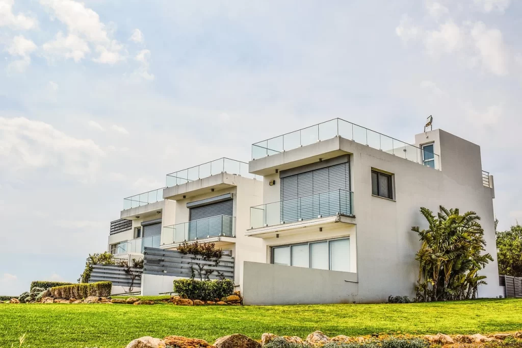 Modern luxury villas with glass balconies and landscaped lawns, representing premium residential living