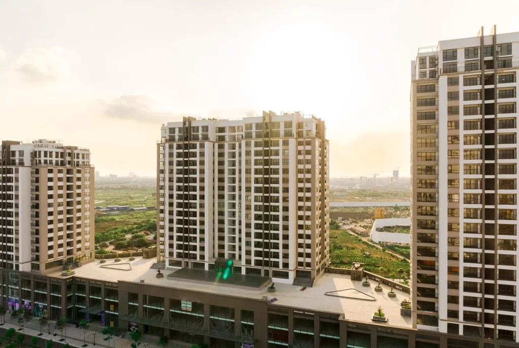 Modern high-rise residential apartments with retail space below – premium luxury flats with commercial amenities in a growing urban area by Shikhar Realty